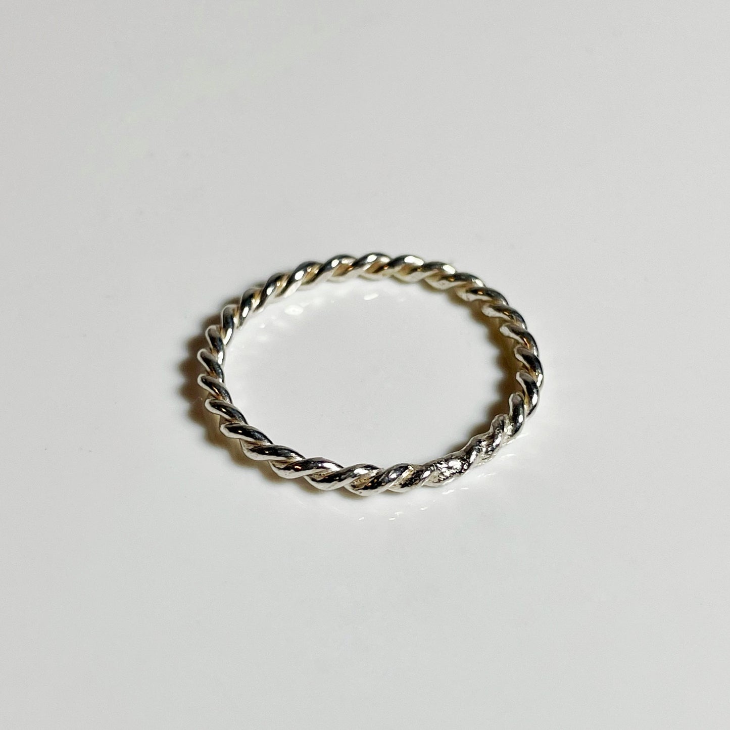 A sterling silver twist stacker ring with a slim profile.