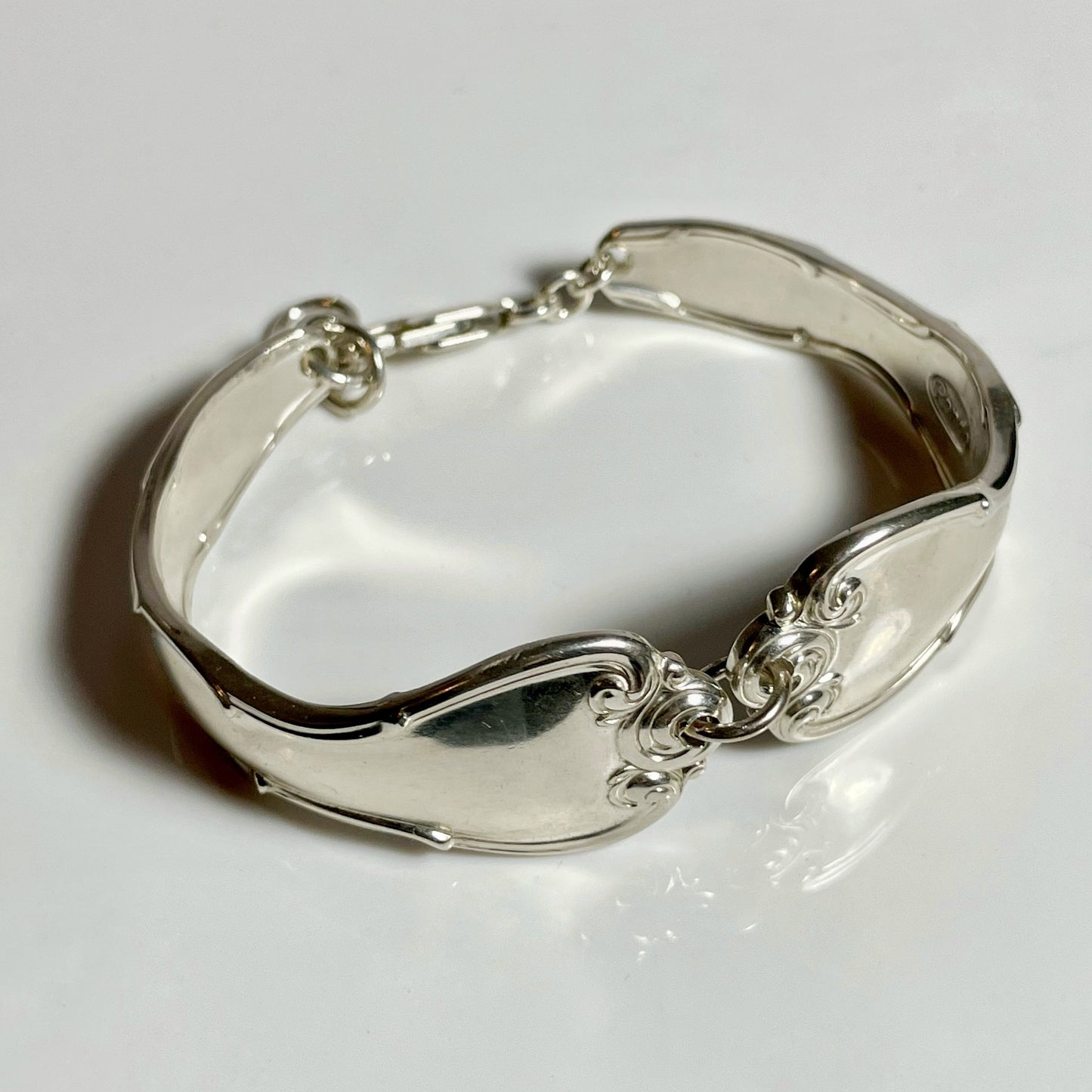 Silver bracelet made of spoon handles.