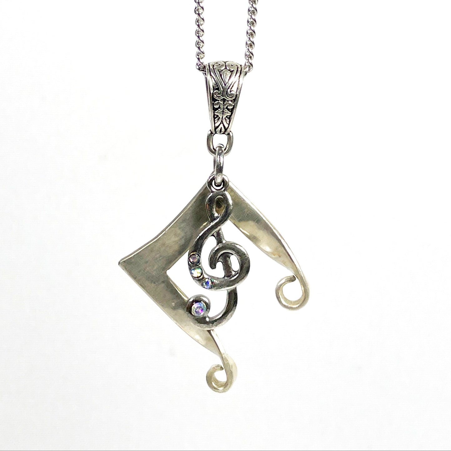 Silver necklace with a decorative pendant on a white background